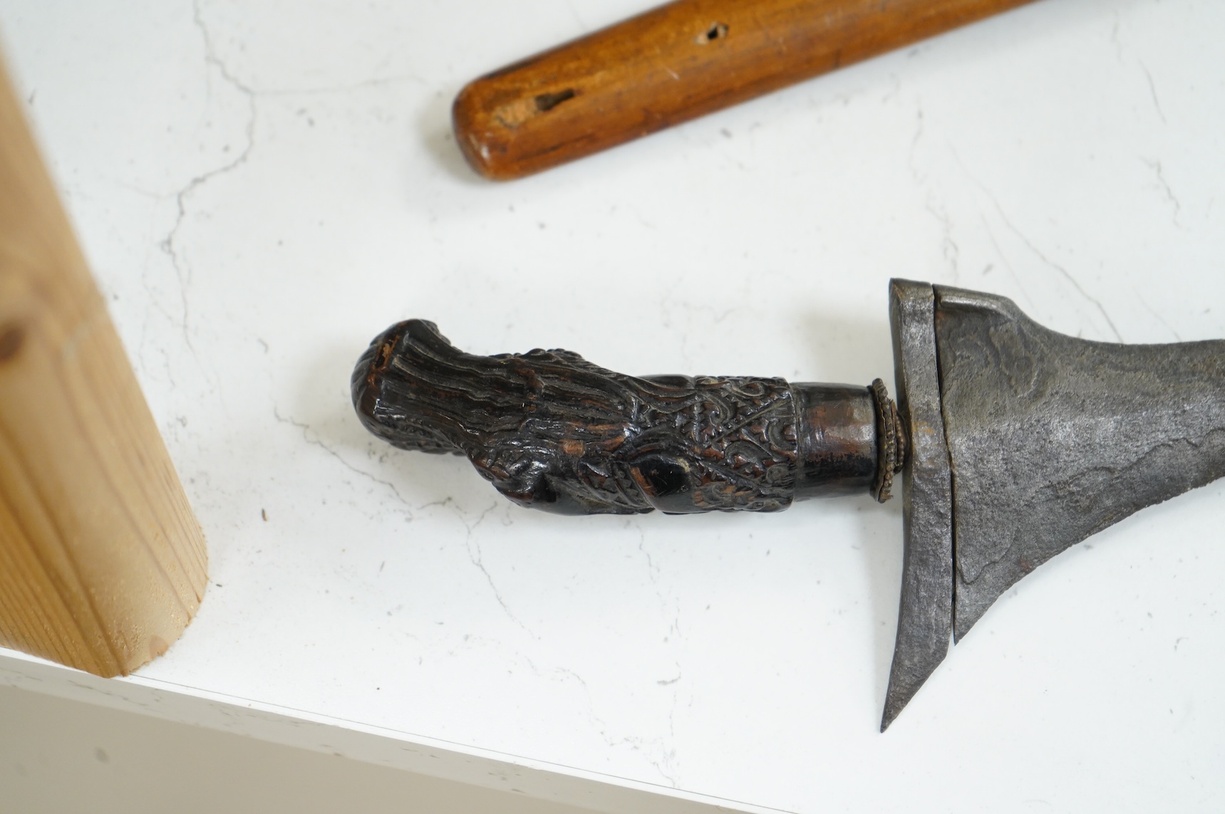 A Javanese dagger kris with straight pamor blade, wooden hilt carved as raksha, in its wooden sheath, together with a decorative dagger bade-bade, with etched blade